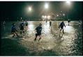 Image of Players in an over-50 women's soccer game in the heavy rain at Woodland Park, Seattle, March 18, 1997