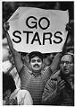 Image of Fan Wane Dallasto holding banner supporting Tacoma Stars soccer team during playoff game at the Tacoma Dome, April 16, 1986