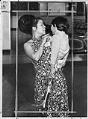 Image of Loan Young of Alderwood Manor with Vietnamese child, Sea-Tac, April 6, 1975